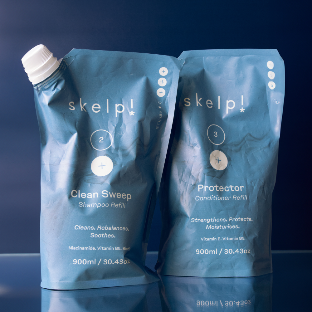 Vegan conditioner & shampoo refill pouches by Skelp for healthy, nourished hair sitting on bathroom shelf