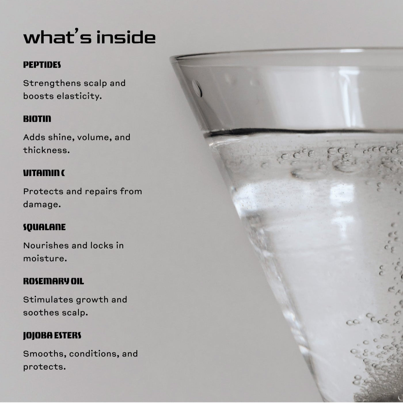 Skelp Gloss Boss Hair Oil on a gray background next to a cocktail glass with water. Text reads ‘What’s Inside’ and lists the key ingredients that nourish, smooth, and add shine to hair.