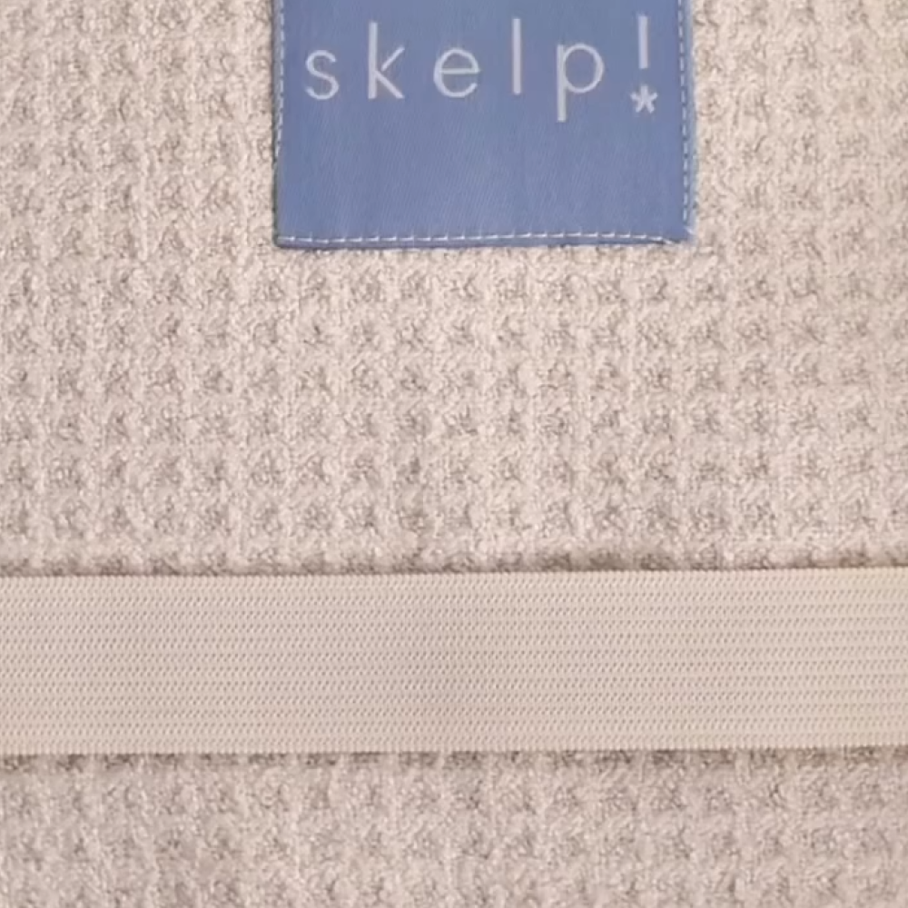 Textile Microfibre Towel with 'skelp!' label showing premium quick drying fabric. Beautiful texture to absorb water.