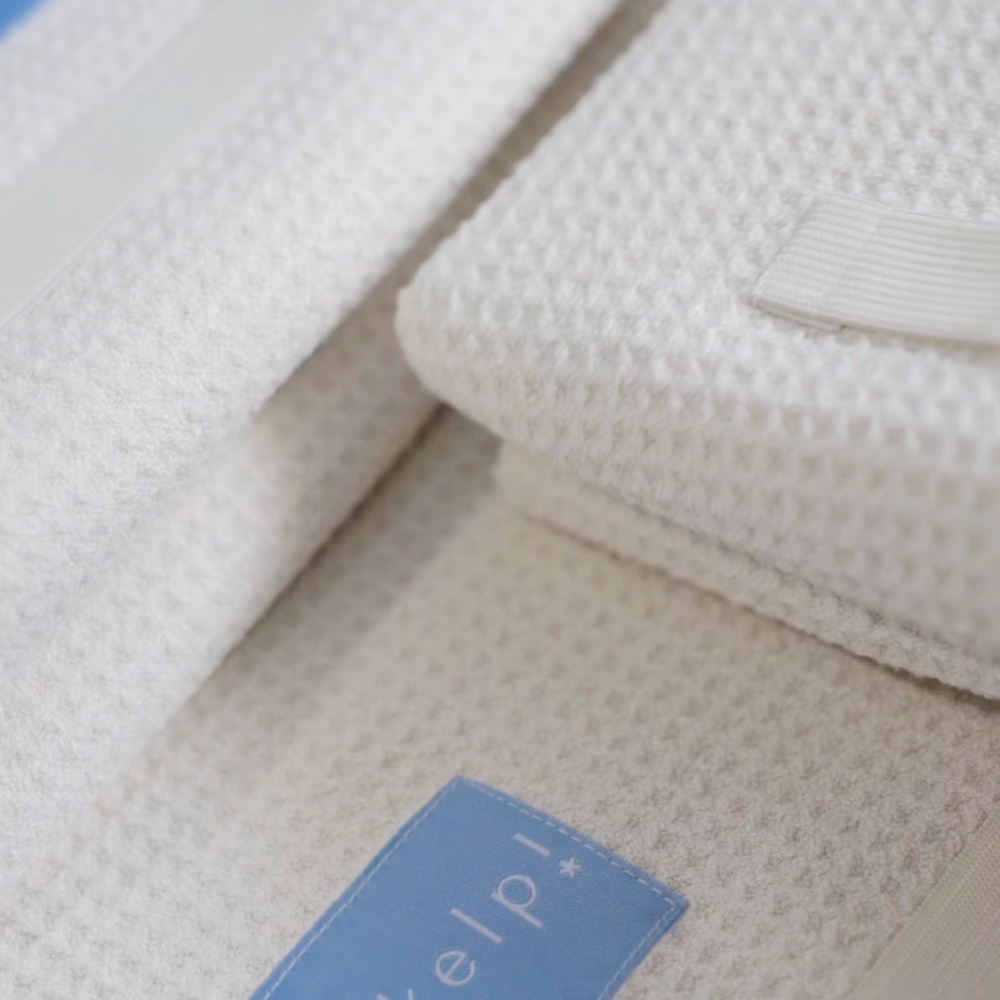 Close-up of 5 skelp Microfibre Towel showing premium fabric and elastic band to secure towel.