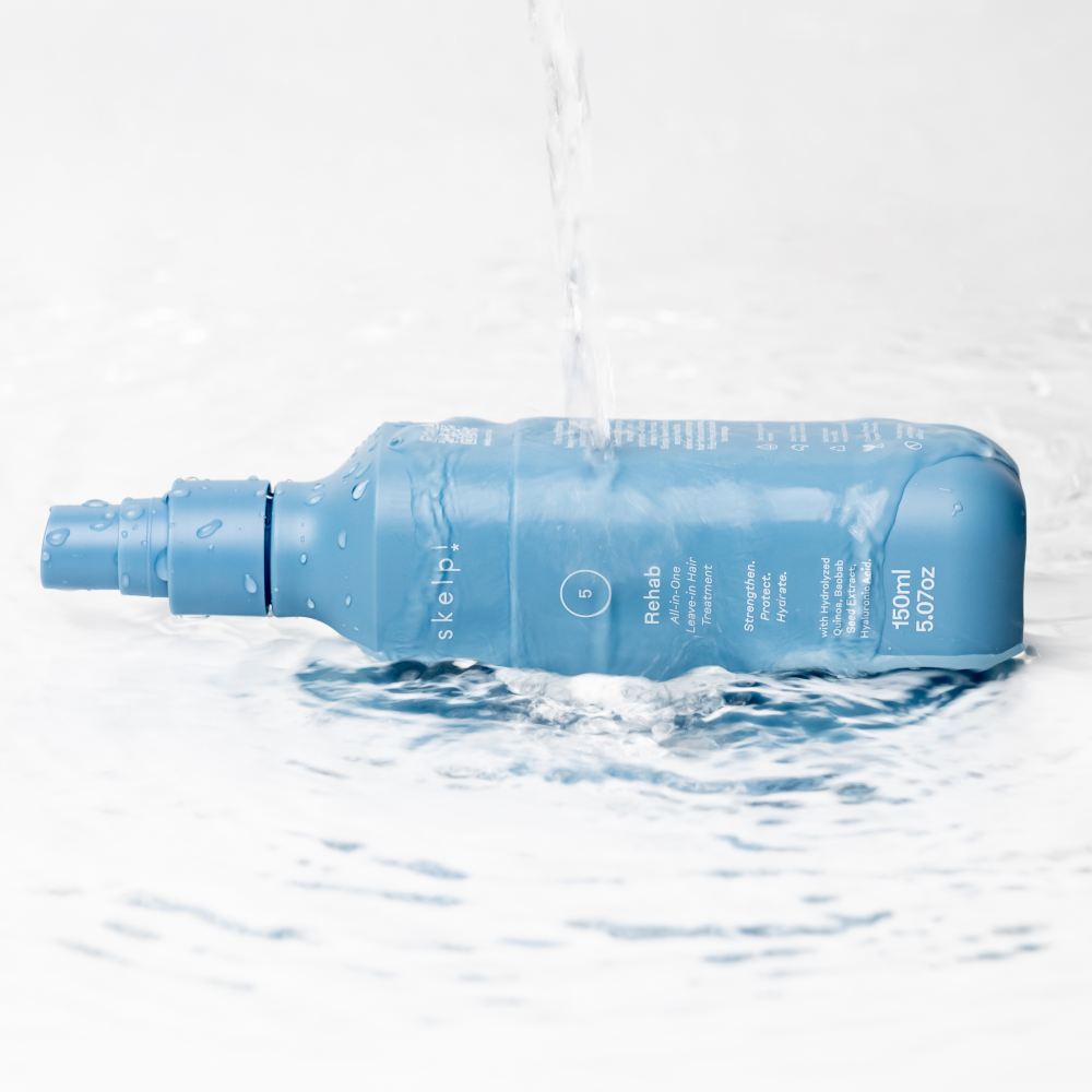 skelp! UV hair treatment lying in pool of water with water pouring over it.