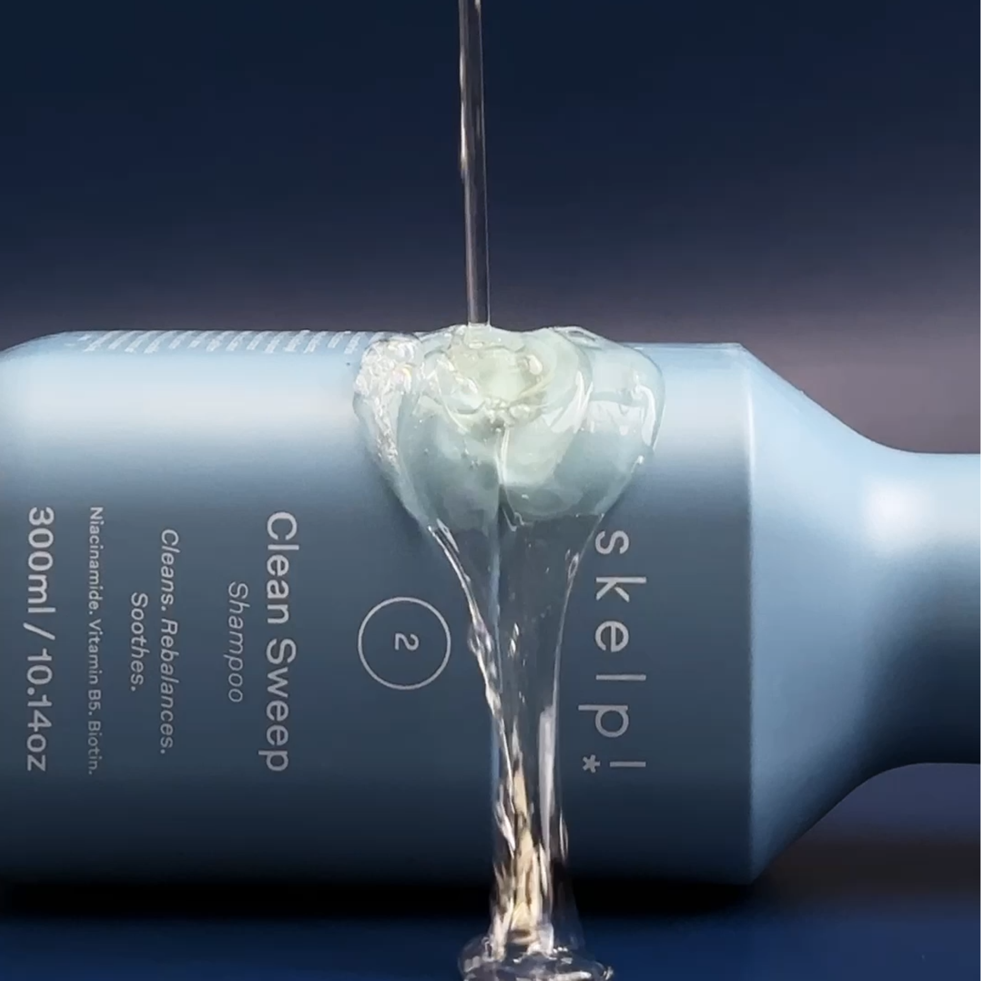 skelp! shampoo bottle Clean Sweep Shampoo with Vegan Shampoo being poured into over bottle.