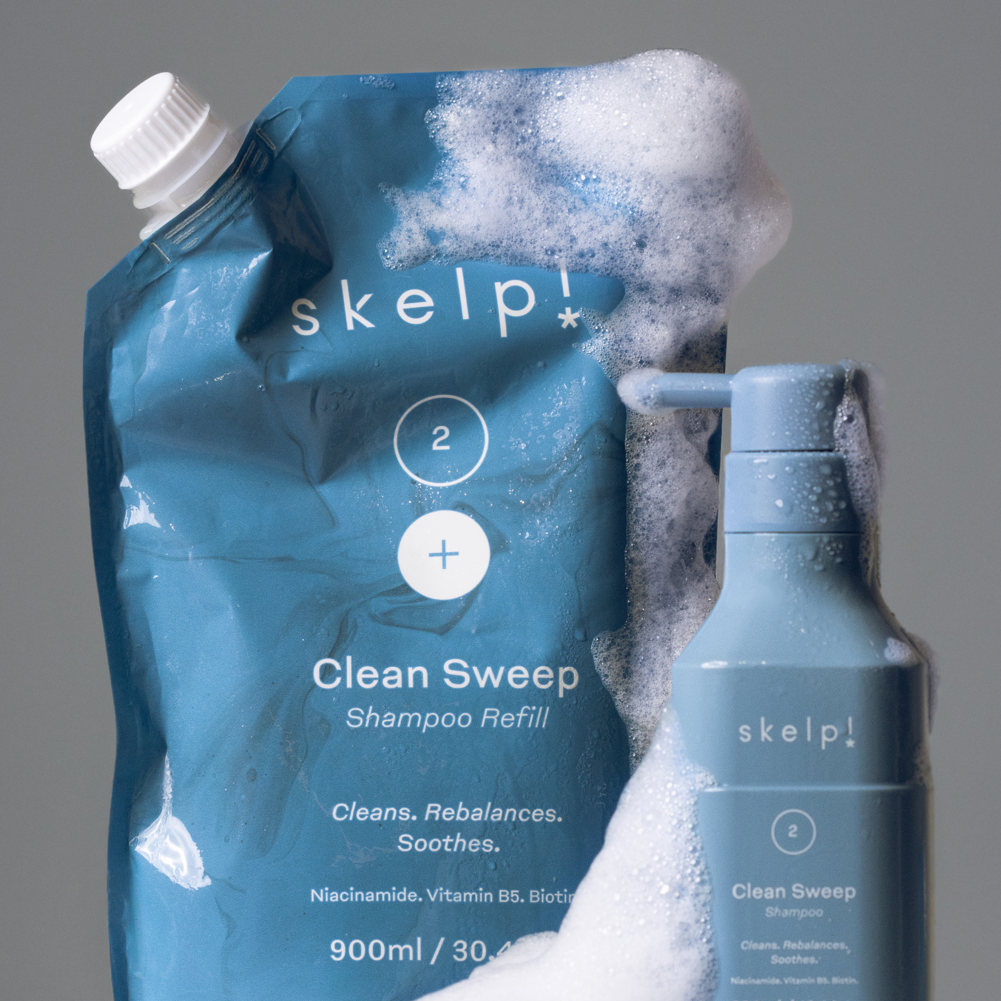 Female applying Skelp shampoo from refill pouch for nourished, healthy hair