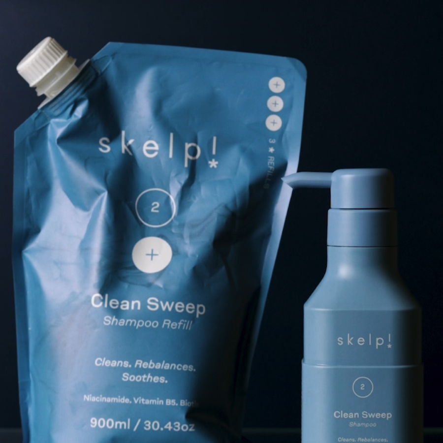 skelp refillable shampoo pouch and recycled shampoo bottle sitting against blue background