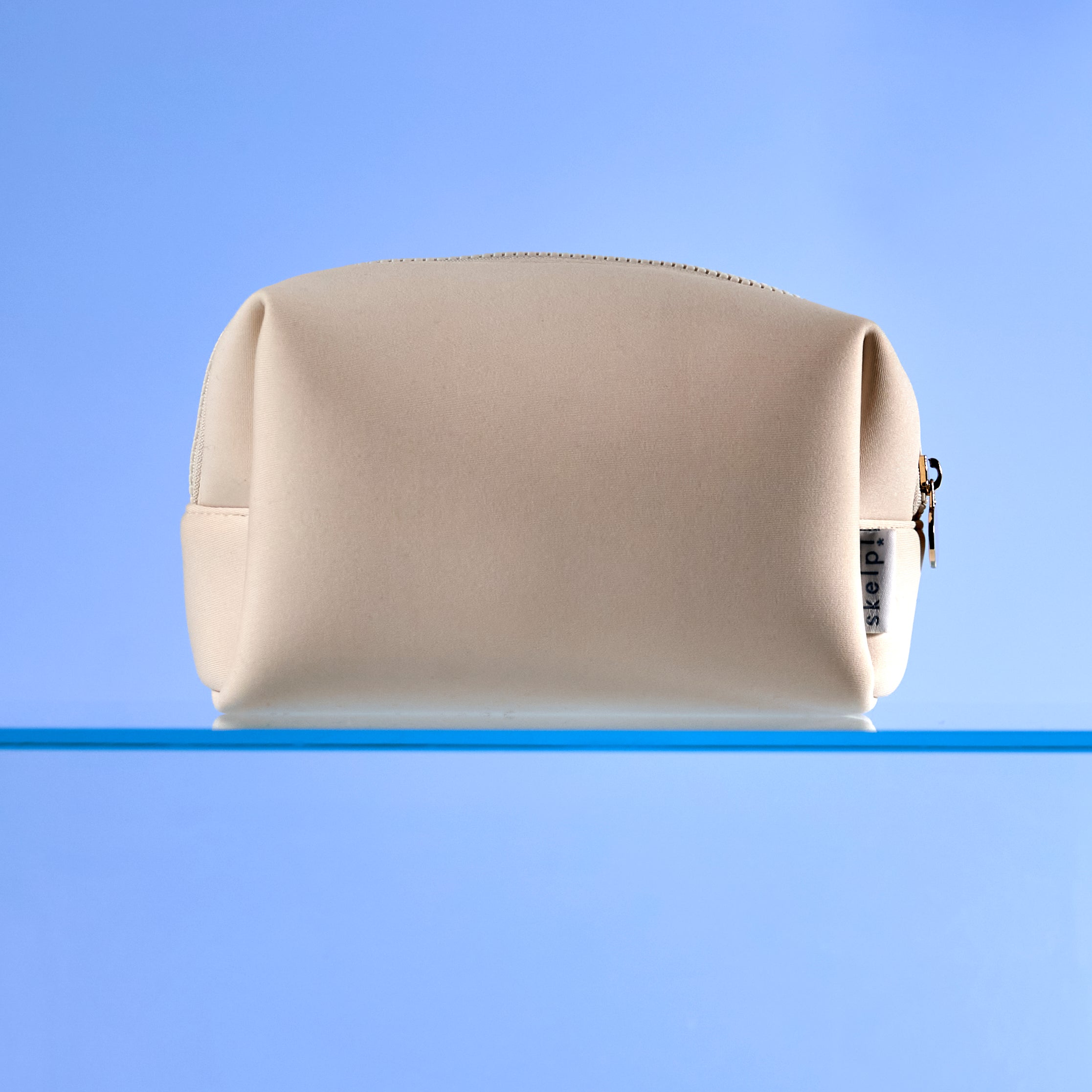 high quality cream makeup bag sitting on bathroom shelf. Shot for summer travel and Christmas