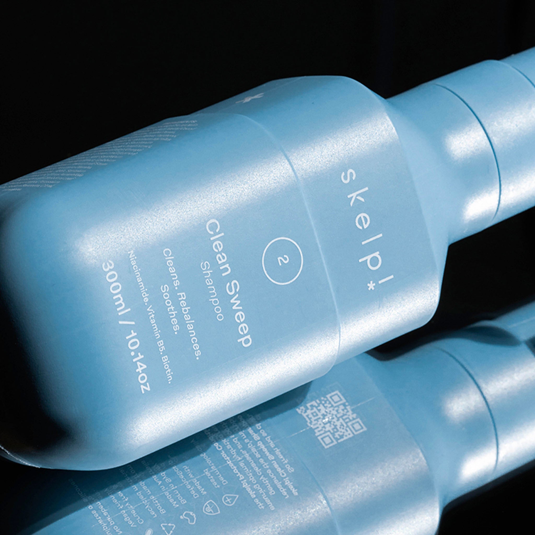 content shot of Skelp Clean Sweep Shampoo with reflection of back of pack.
