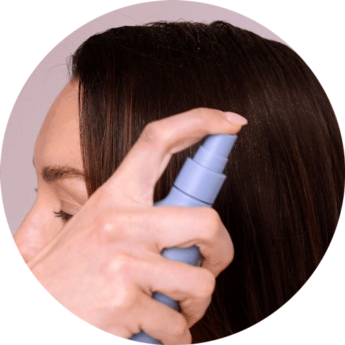 Gif of model spraying head first pre-cleanser onto scalp 