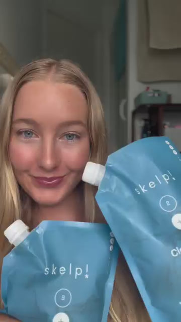Customer squeezing Skelp conditioner refill pouch to refill bottle at home