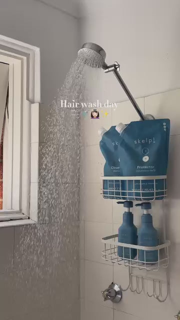 Woman using Skelp refillable conditioner in the shower for soft, nourished hair