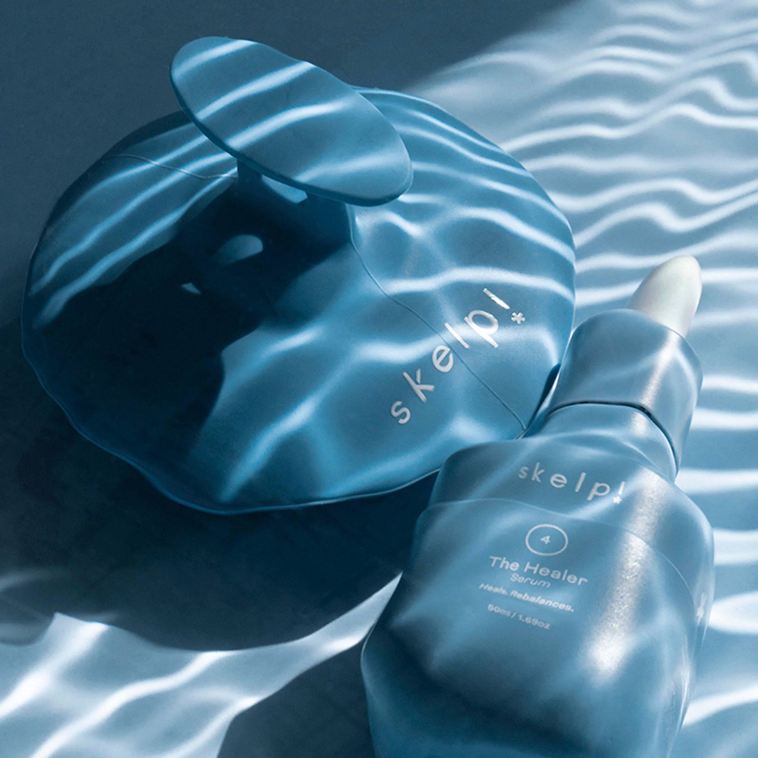 skelp! serum and scalp brush product shot in water