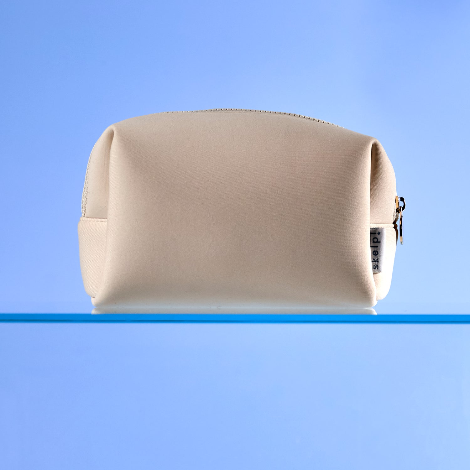 high quality cream makeup bag sitting on bathroom shelf. Shot for summer travel and Christmas