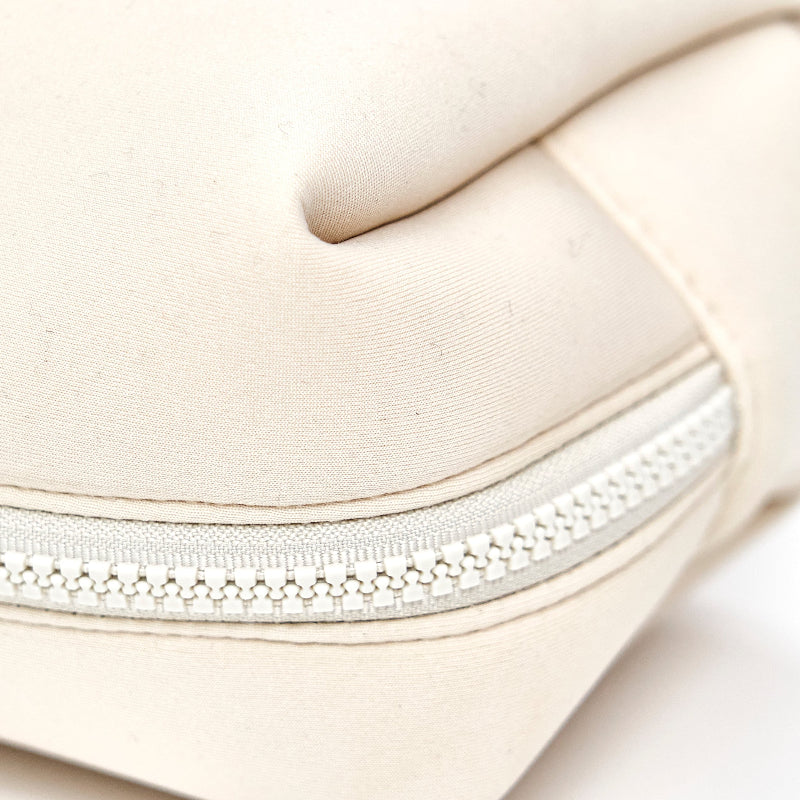 Close-up of a beige cosmetic bag with premium zipper for travel and storage