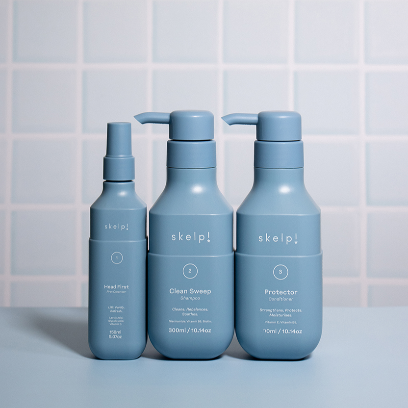 beautiful bathroom shot of shampoo conditioner and pre-cleanser for skelp haircare. 
