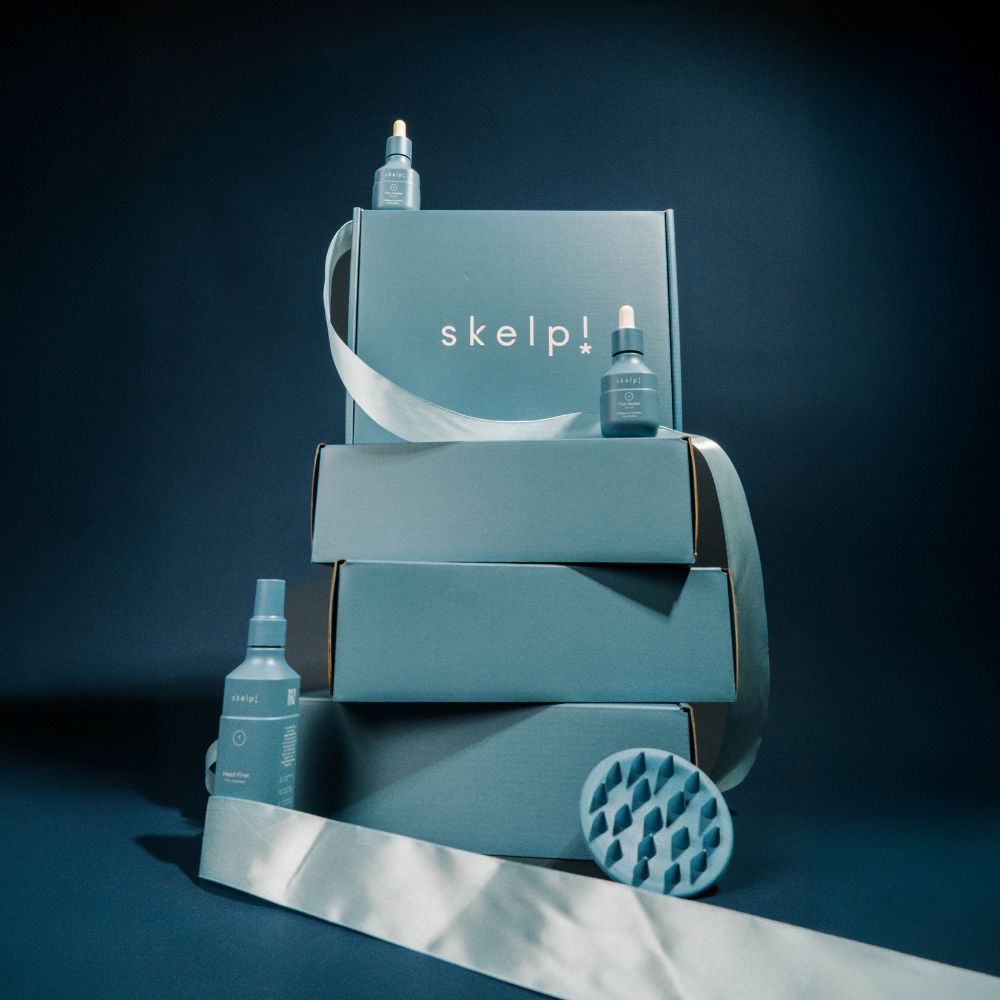 Skelp! haircare product set with bottles and boxes on a dark background
