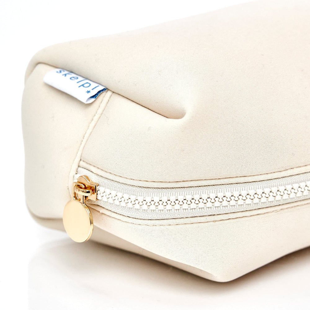 skelp! haircare cosmetic bag, cream neoprene with gold detail. 